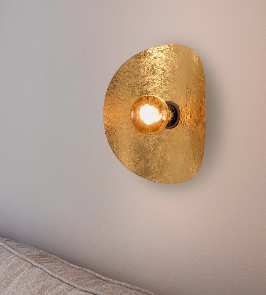 Golden wall lamp on white wall