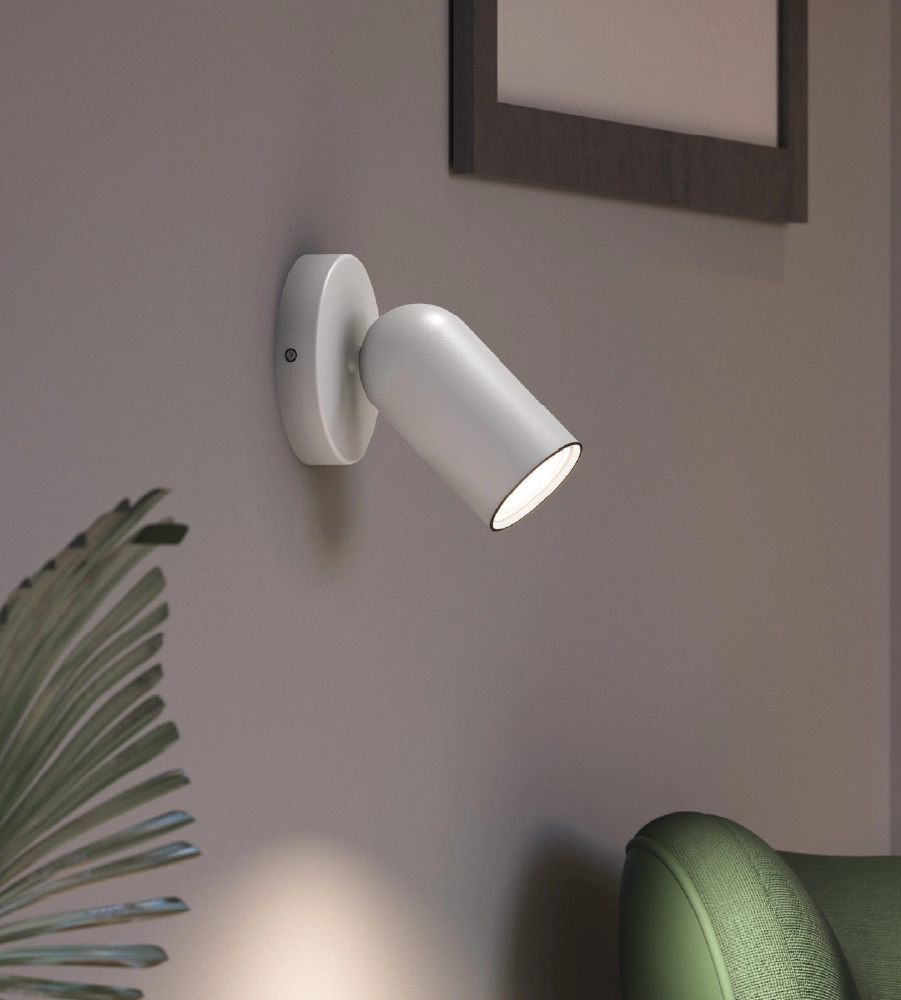 White Philips wall lamp on white inner wall with green chair